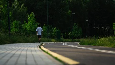 A guy walks along a bike path, a healthy lifestyle Stock Photos