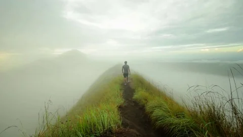A guy walks along the road and disappears in the fog. Stock-Footage 82147687