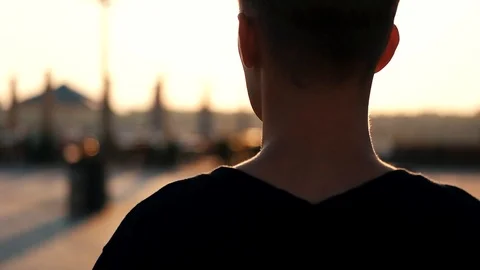 Guy walks around the city at sunset Stock Footage 118578609