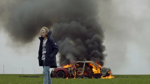 The guy walks away from the burning red car, car crash Stock Footage 95191721