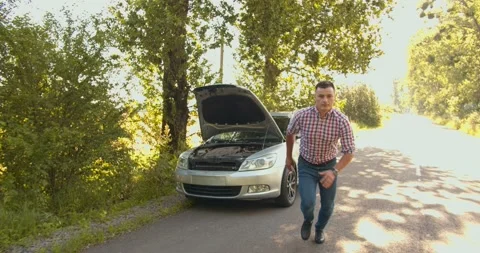 The guy walks away from the burning red car, car crash survivor. shot to VFX Stock Footage 134163023