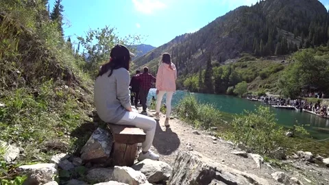 A guy walks with a backpack along the lake. Stock-Footage 161808789