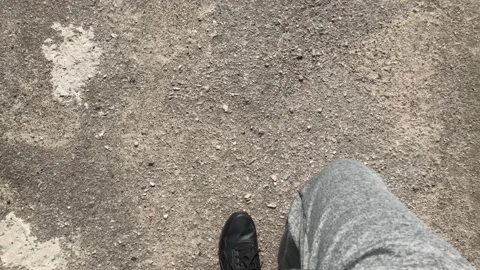 The guy walks down the road in the frame you can see his feet and shoes Stock Footage 161006007
