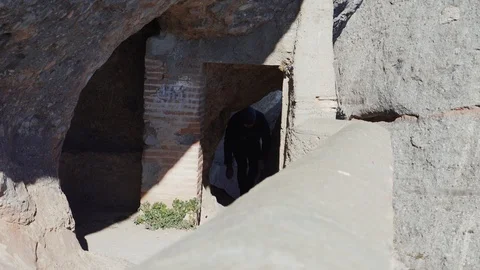 A guy walks on the edge of a steep mountain slope leaning on the railing Stock Footage 101270102