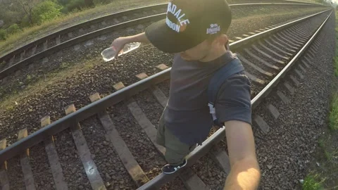 The guy walks in the evening in the summer around the city balancing on a narrow Stock Footage 169513236
