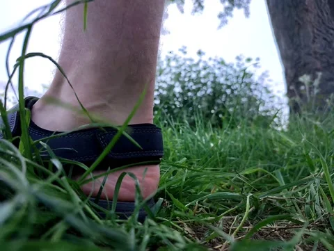The guy walks on the grass. Stock Footage