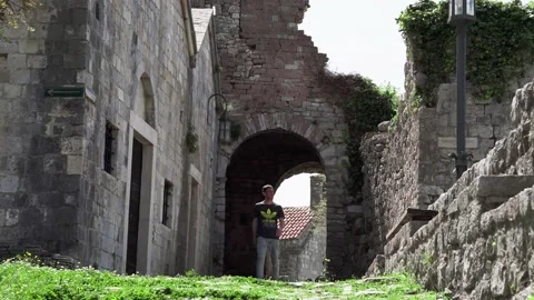 The guy walks in the Old Bar fortress in Montenegro Видео 196125898