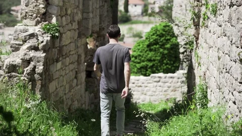 The guy walks in the Old Bar fortress in Montenegro Stock Footage 196126013