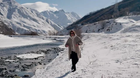 The guy walks in the snow in the mountains Stock Footage 169812482