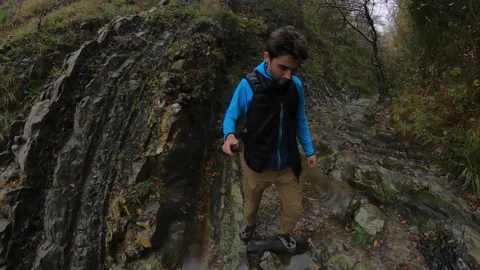 A guy walks on a stone surface in rainy weather Stock Footage 172001585