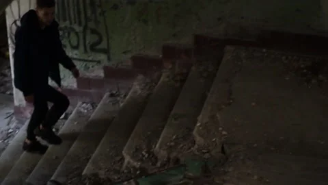 Guy walks through an abandoned building Stock Footage 130739584