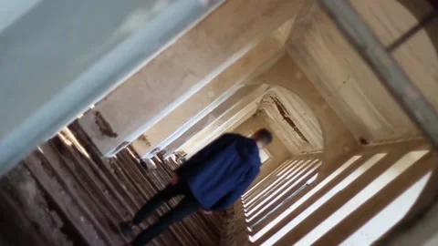 Guy walks through an abandoned building Stock Footage 130739882