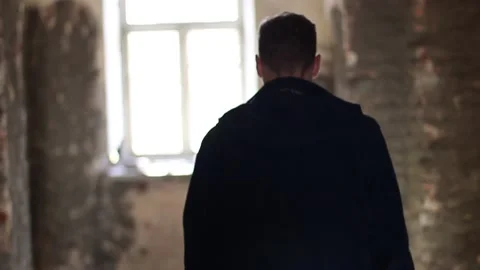 Guy walks through an abandoned building Stock Footage 130740181