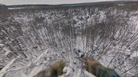 A guy walks through the dry grass in a field in winter. From the first person. Stock Footage 321354499