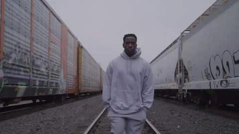 Guy Walks On Train Tracks With Hands In Pockets Stock Footage 270325702