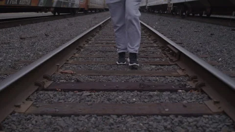 Guy Walks On Train Tracks In Sweatsuit Stock Footage 270325737