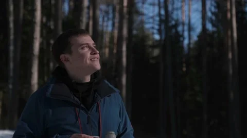 The guy is warmed by tea from a thermos Video stock 170481296