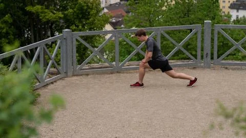 The guy warming up before training with a beautiful view of the city in Germany Stock Photos