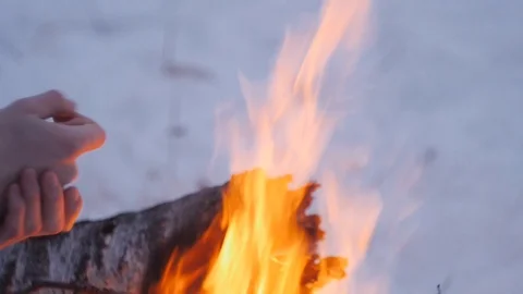 Guy warms his hands by the fire in winter Stock Footage 122611187