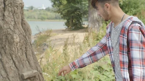 Guy was Tired and Leaned Against the Tree Stock Footage 95540362