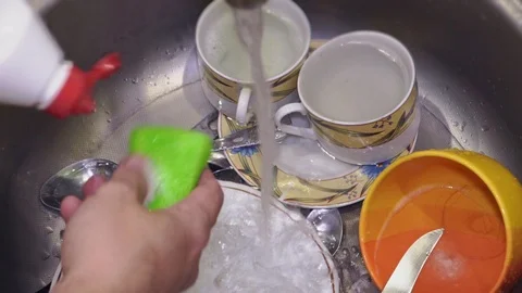 The guy washes dishes in the kitchen close-up in fast motion Stock Footage 104380008