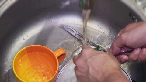 The guy washes dishes in the kitchen close up Stock Footage 104380082