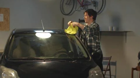 The guy washes his car with a rag. Medium shot Stock Photos