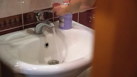 The guy washes his hands in the bathroom sink.a man washes his hands with soap Stock Footage 264888216