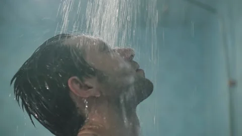 Guy washes in the shower after training from the tap water flows1 Stock Footage 138316732