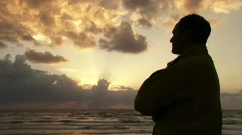 Guy watching sunset at the beach Vídeo Stock 20510384