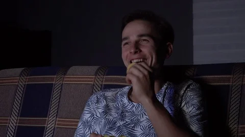 The guy is watching TV laughs, the fun guy is watching TV.Close up Stock Footage 126093553