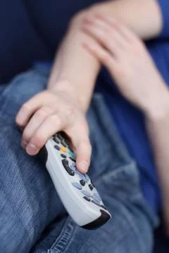 Guy watching tv with remote Stock Photos