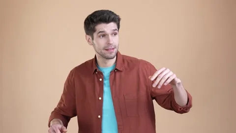 Guy wave hand gesture friend not recognize isolated pastel color background Stock Footage 169939216