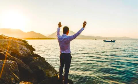 Guy waving hands at the shore Stock Photos