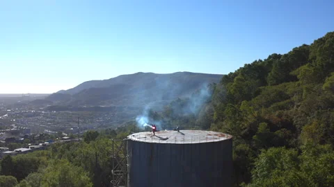 Guy is waving a signal light while standing on a high tower Stock-Footage 143069830