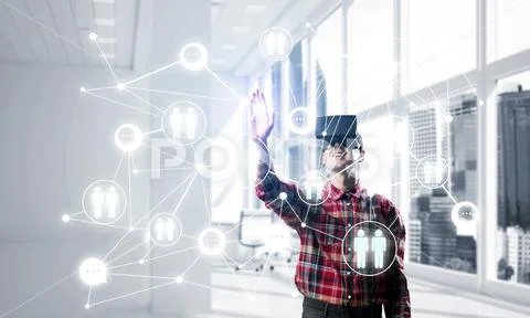 Guy wearing checked shirt and virtual mask reaching hand to touch screen Stock Photos