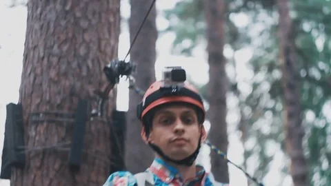 The guy wearing a helmet unstrapped mount from the cable car Video stock 73476115