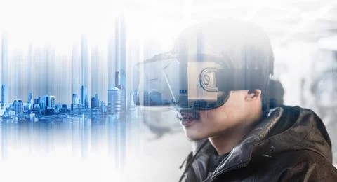 A guy wearing virtual reality goggles, with double exposure modern buildings Stock Photos