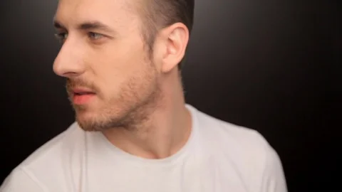 The guy in the white shirt on black background Stock Footage