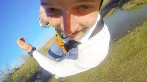 The guy in the white shirt is jumping backwards off a bridge Stock Footage 52430887
