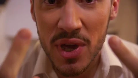A Guy in a white Shirt Swears at the Camera. Closeup Stock Footage 163467837