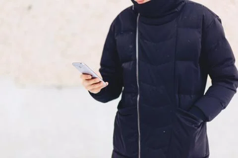 Guy in winter jacket writes sms Stock Photos