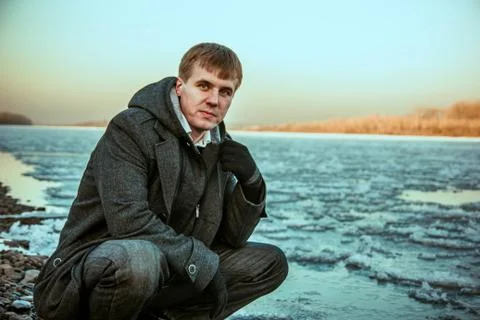 Guy winter at the river Stock Photos