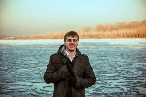 Guy winter at the river Stock Photos