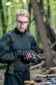 Guy in the woods tests his weapons for shooting sports Stock Photos