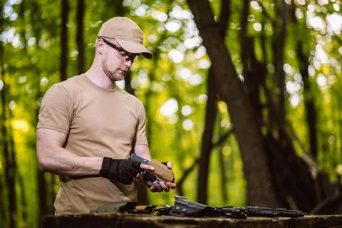 Guy in the woods tests his weapons for shooting sports Stock Photos
