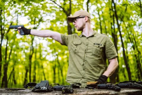 Guy in the woods tests his weapons for shooting sports Stock Photos