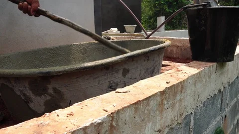 Guy workers are mixing cement for the construction of the building  Видео 117104635