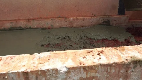 Guy workers are mixing cement for the construction of the building  Stock Footage 117104896