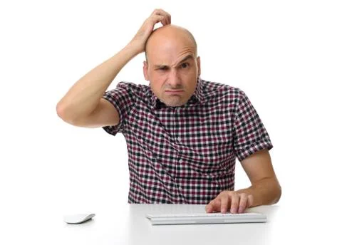 Guy working on a computer and scratching his head Stock Photos